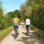 Couple bicycling on Wild Goose State Trail in Dodge County