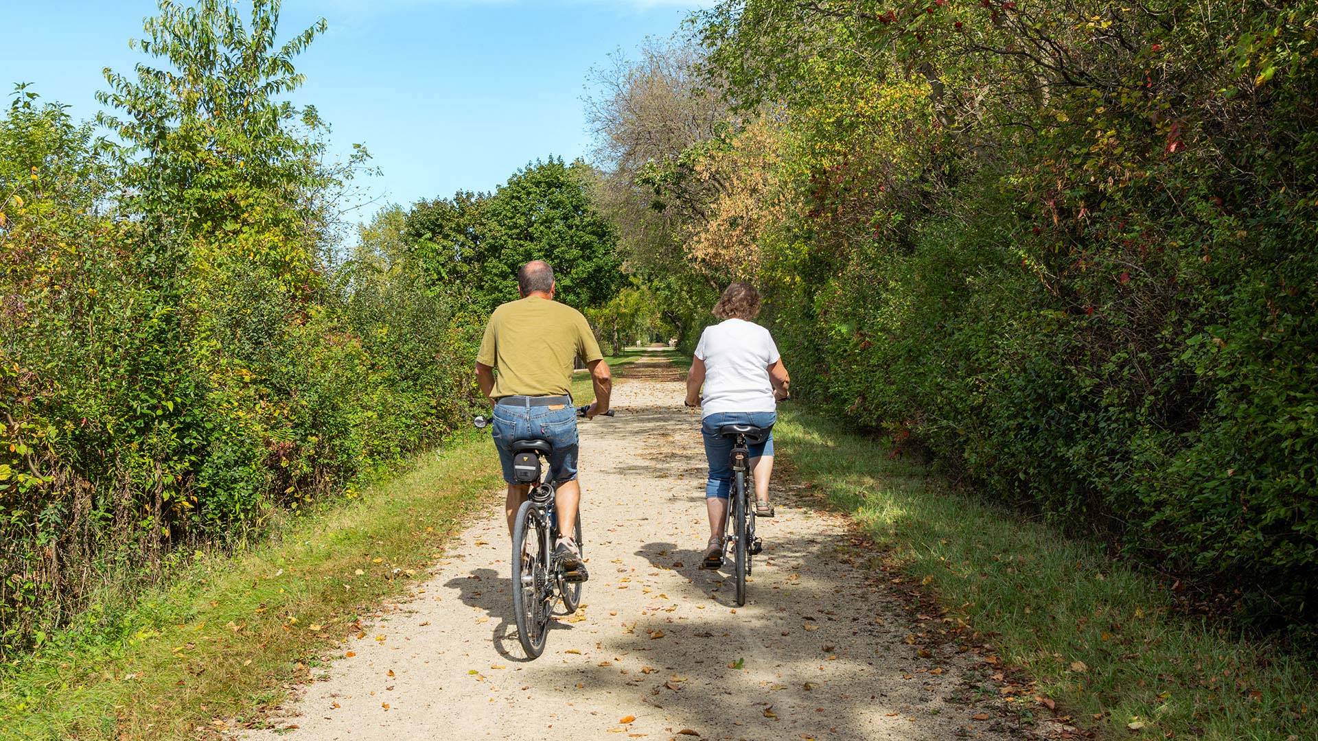 Couple bicycling on Wild Goose State Trail in Dodge County
