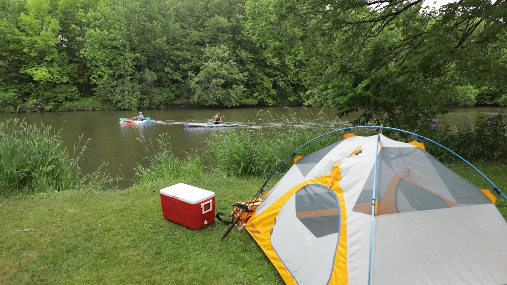 Tent camping with kayakers in the river