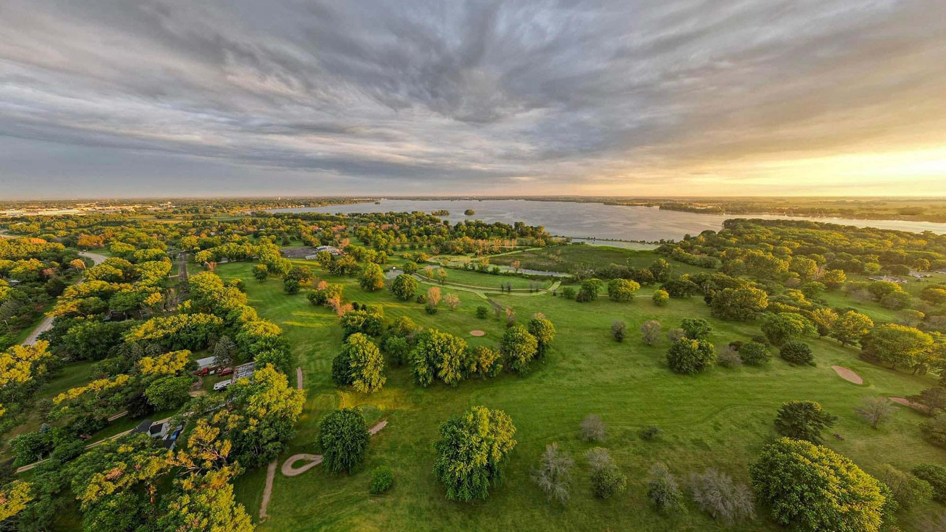 Aerial view of Beaver Dam Lake with a sunset in the distance