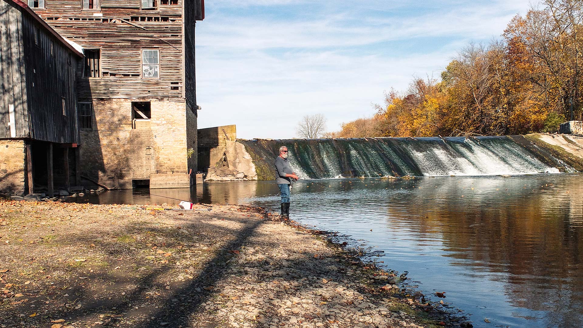 Man fishing on Crawfish River in Autumn