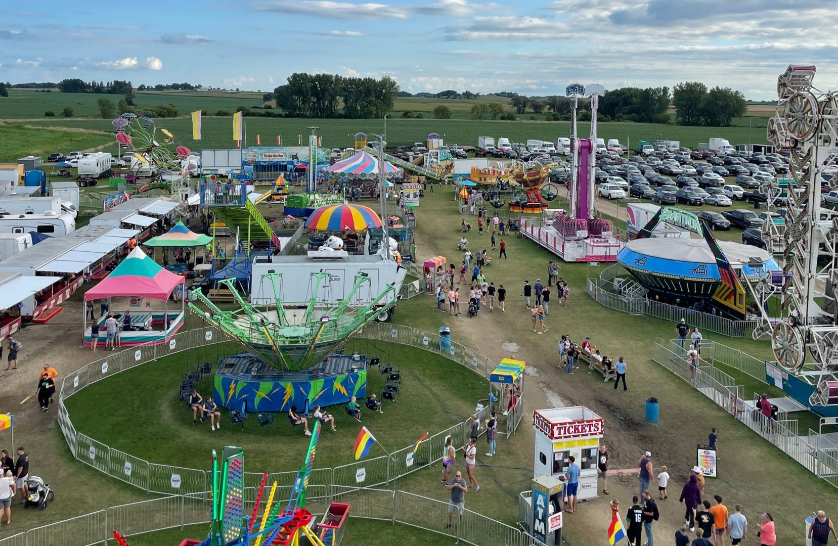 Overview of the fairgrounds including midway rides