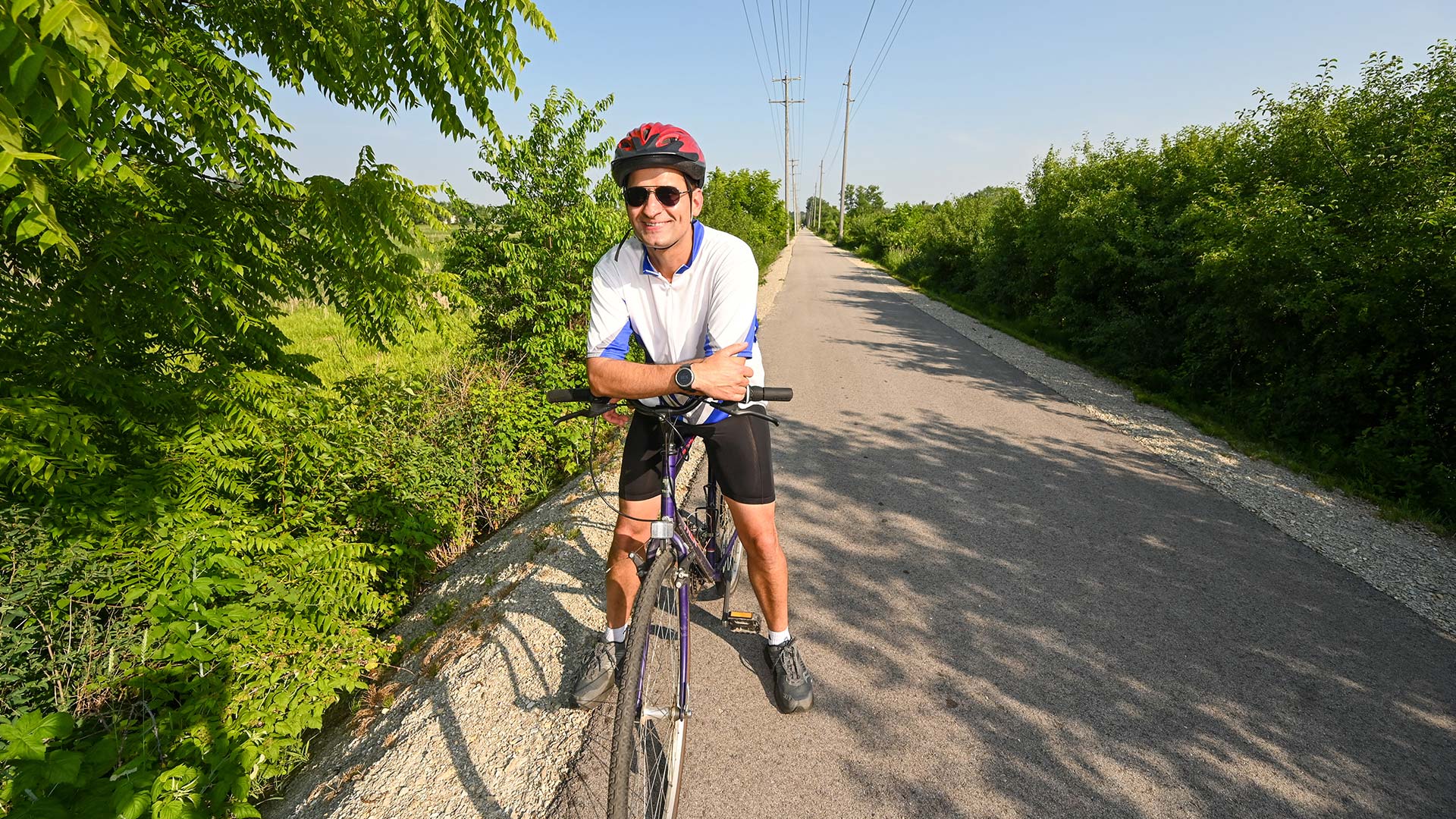 Man standing with his bike on Interurban Trail Watertown