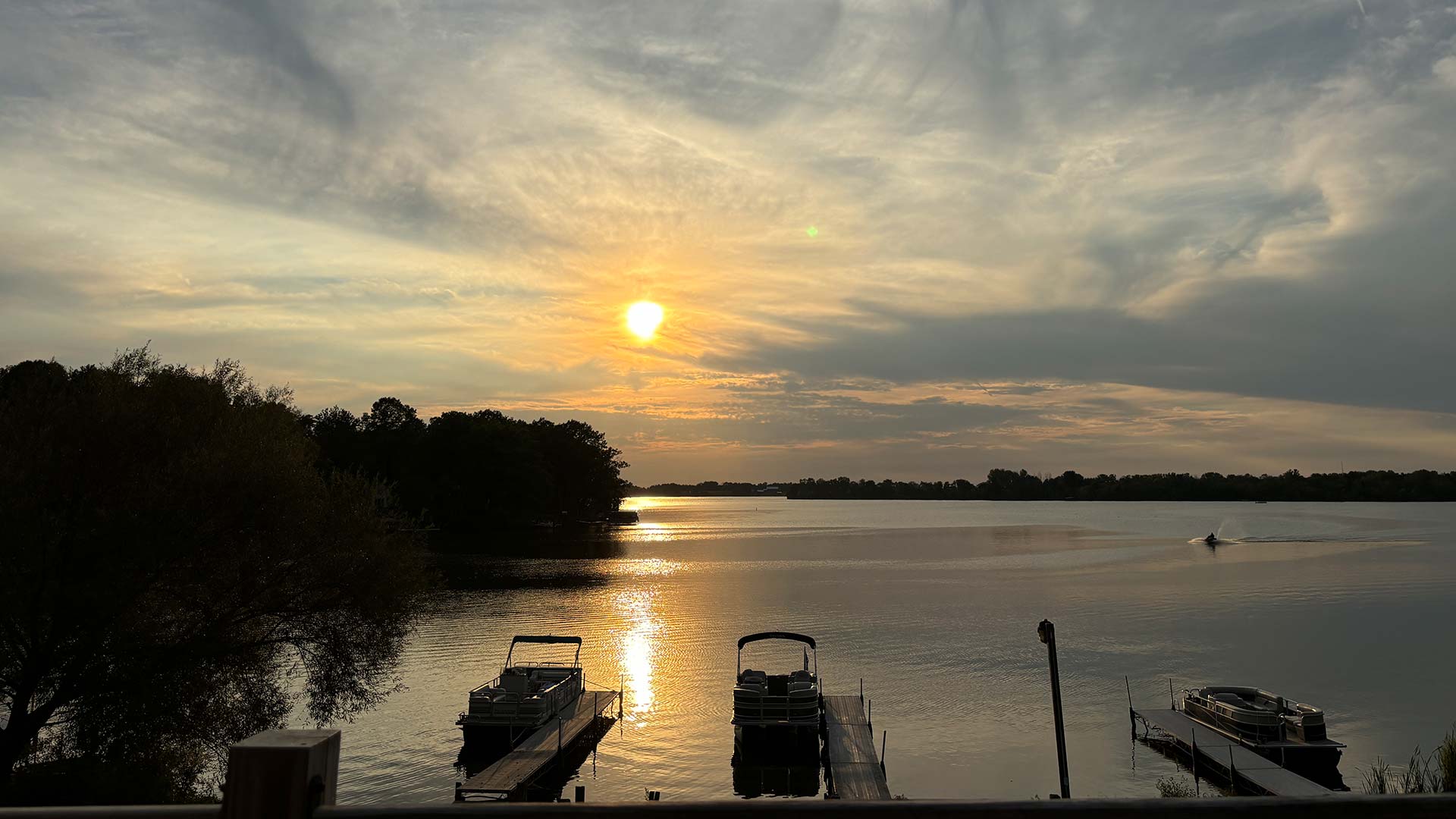 Docked boats on the lake at sunset