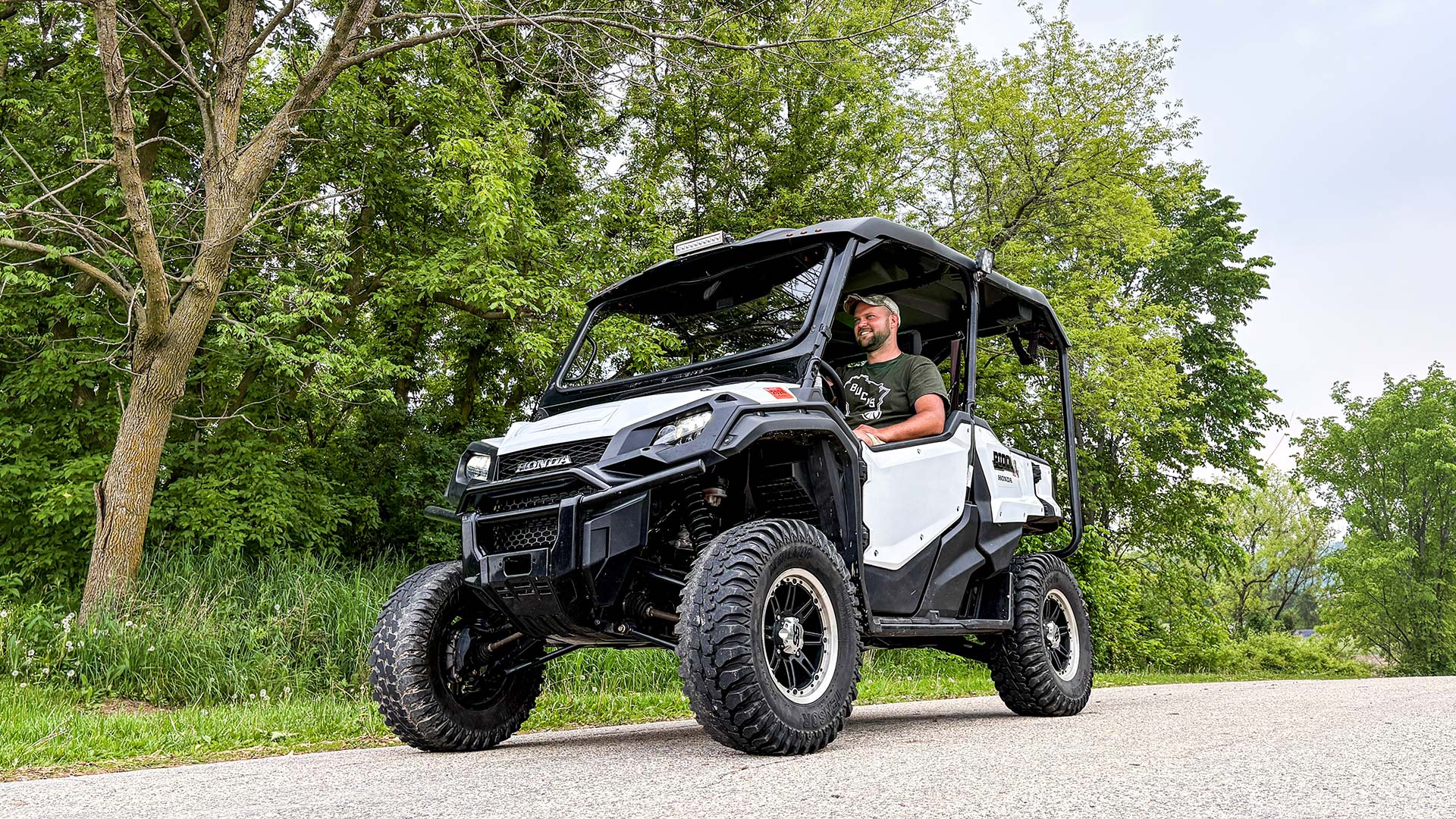 Man riding in UTV on gravel trail
