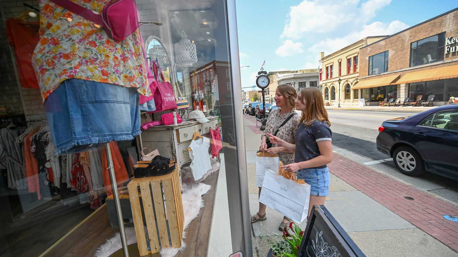 Mother and daughter standing outside shop in historic downtown Watertown in Dodge County Wisconsin